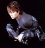 Gackt sitting with his legs crossed.